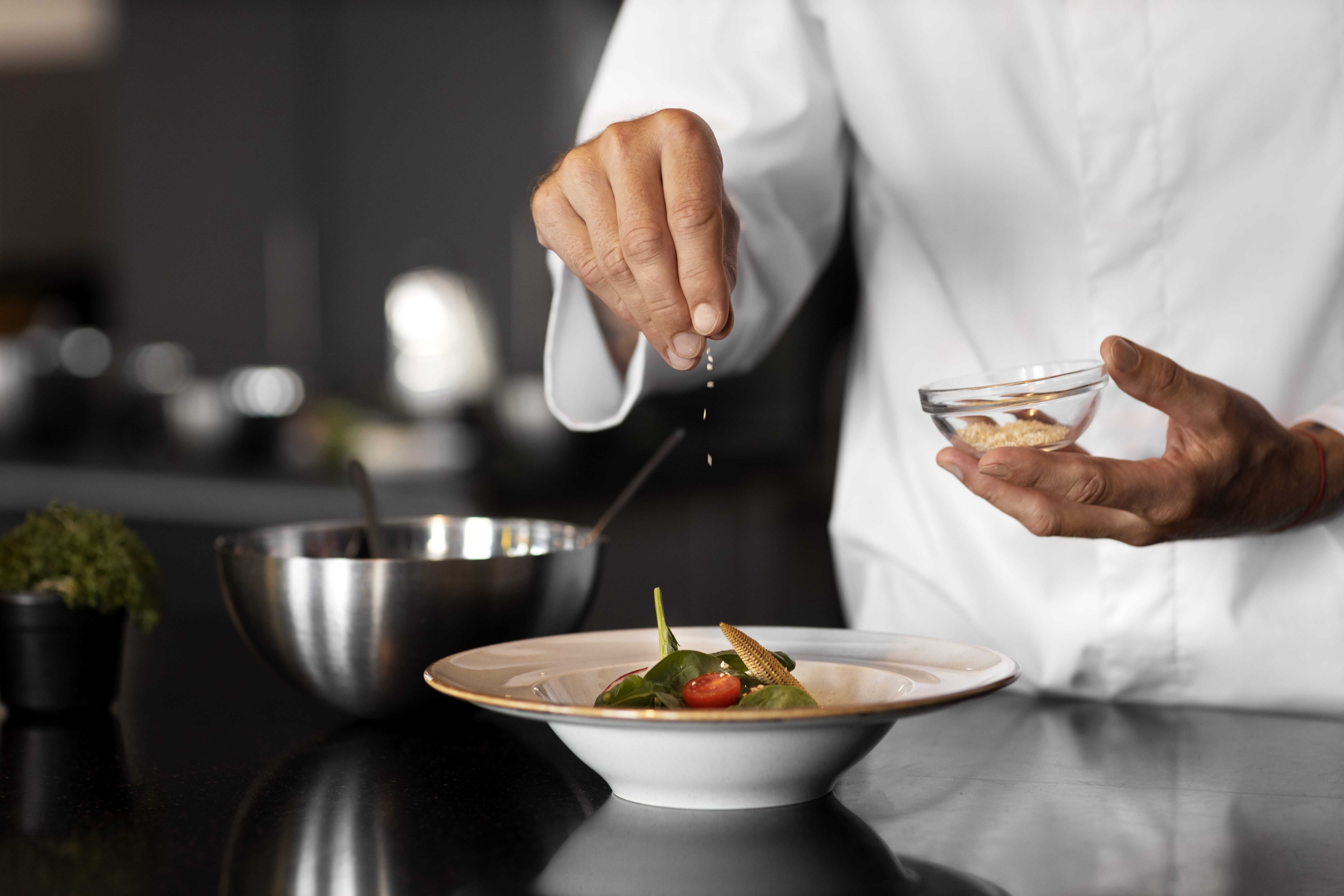 image of a chef sprinkling salt
